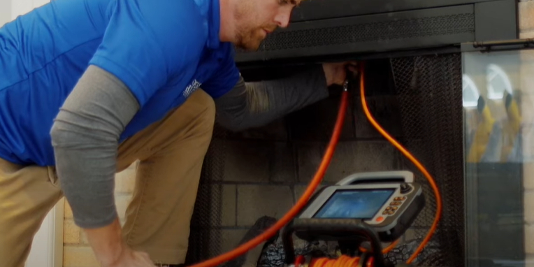 Inspection chimney technician performing an inspection
