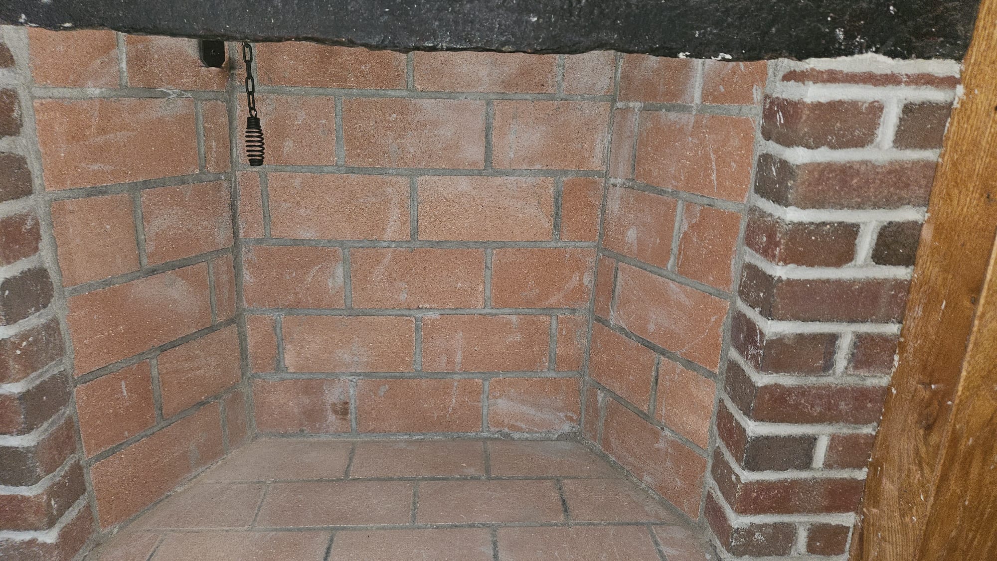 Rebuilt firebox and damper – North Stonington, CT Rebuilt firebox with new firebrick and damper chain in North Stonington, Connecticut