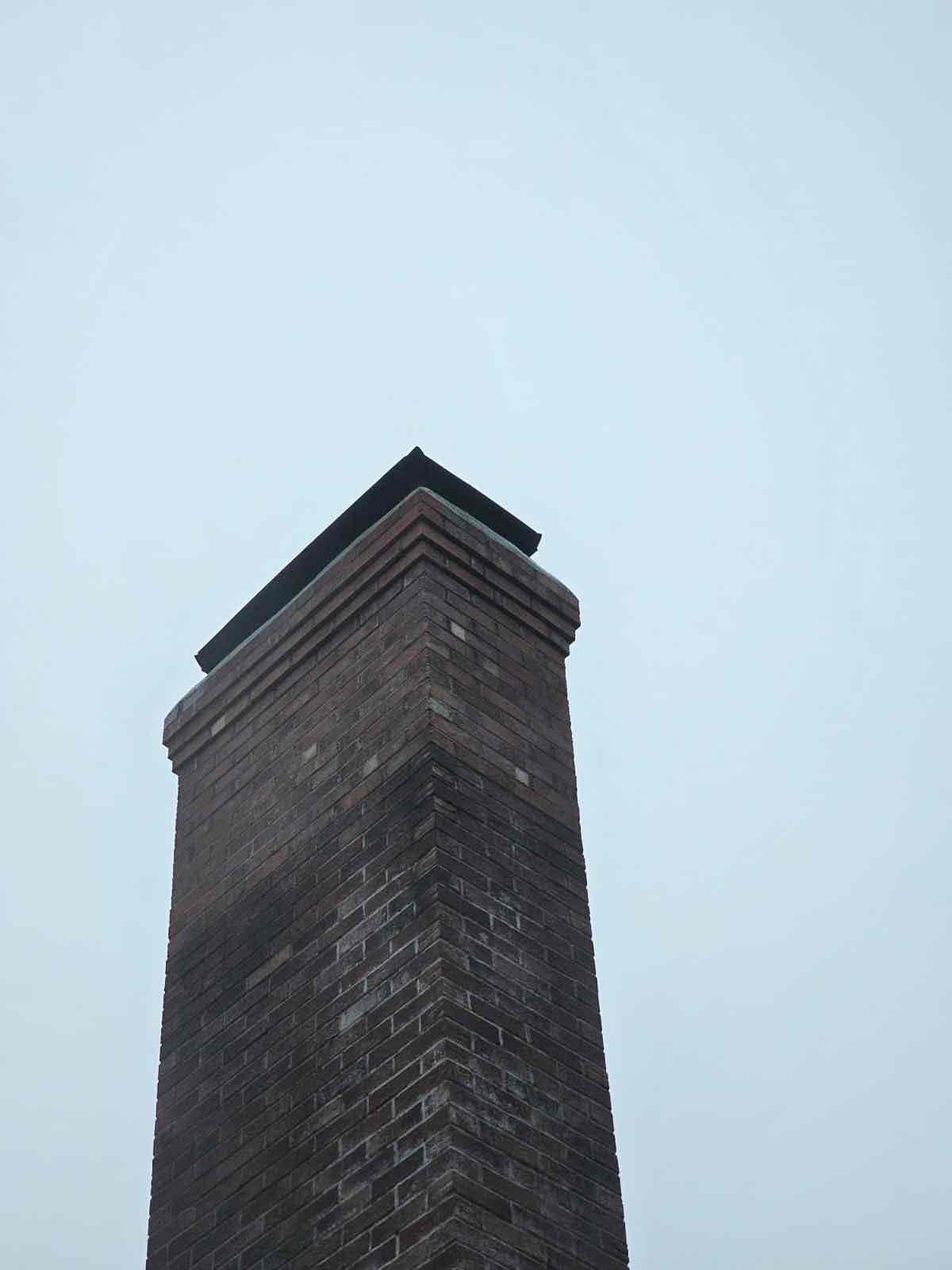 bolton-ct-chimney-rebuild-full-height Completed chimney masonry and cap work on a Bolton, Connecticut home