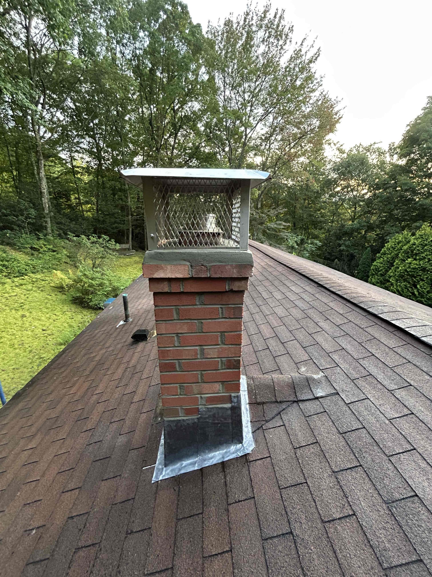 bristol-chimney-rebuild-front Finished partial brick chimney rebuild with cap in Bristol, CT