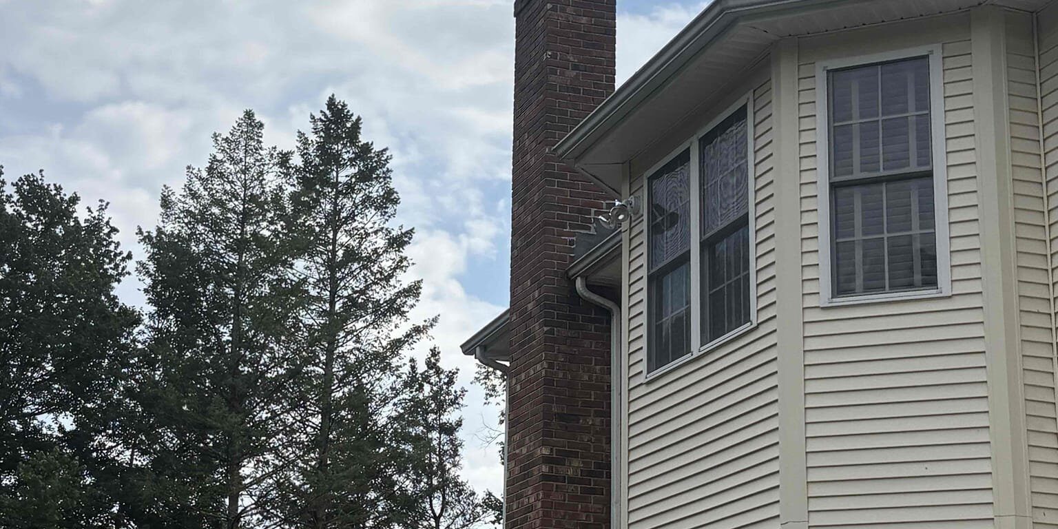 Restored chimney and cap – Burlington, CT Restored brick chimney and cap on a Burlington, CT home.