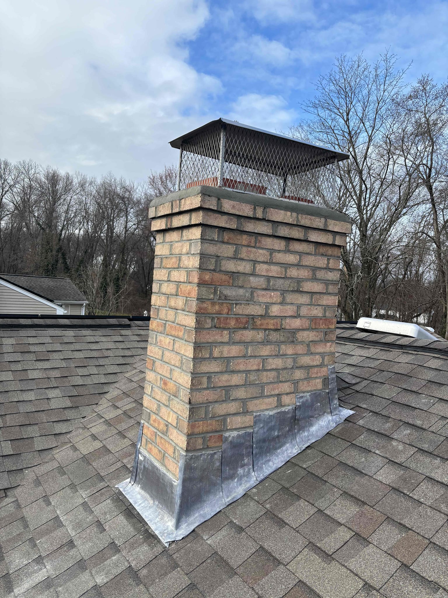 Finished partial brick chimney rebuild with new flashing and cap in Enfield, CT