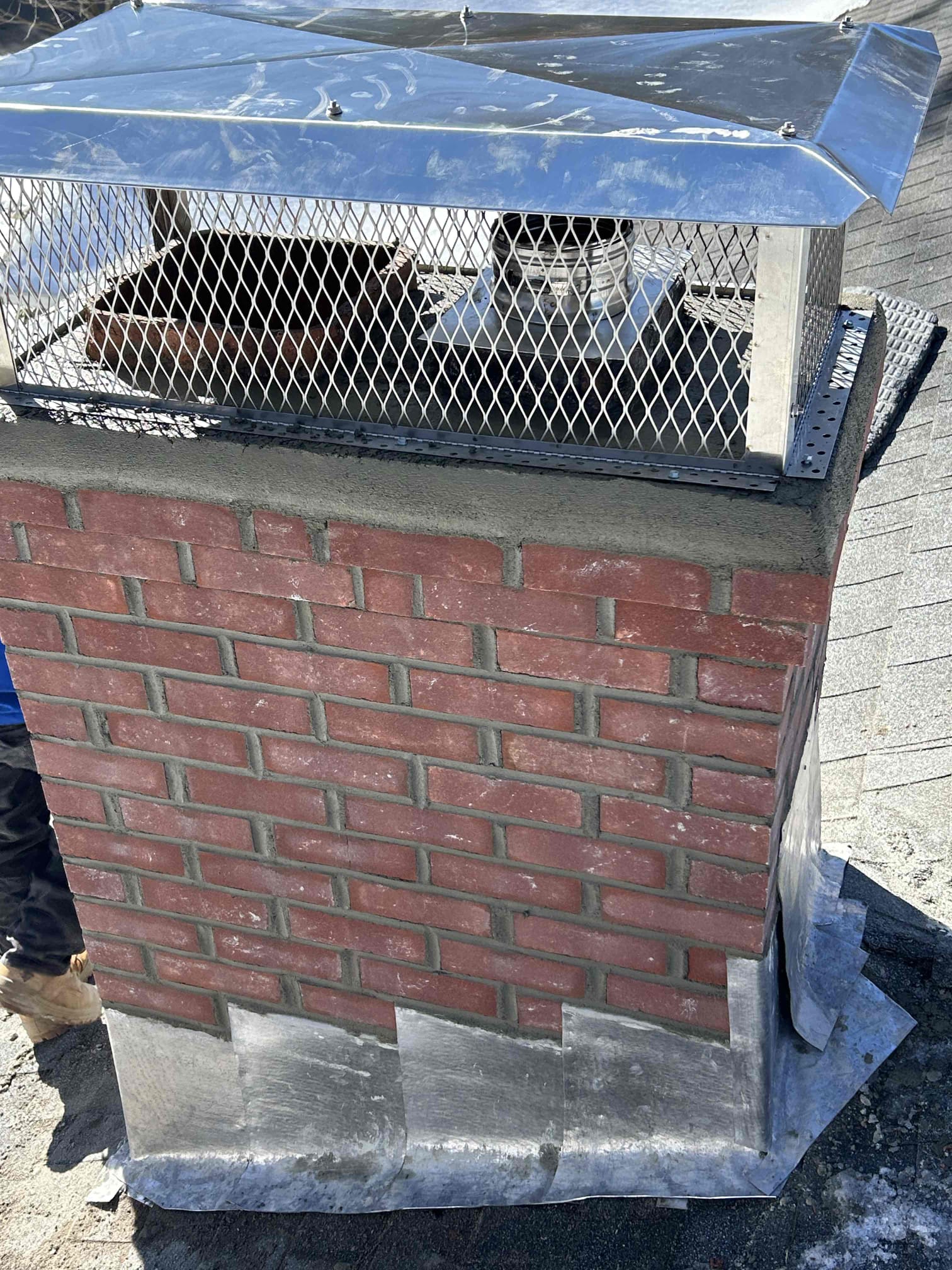 Completed brick chimney rebuild with crown, cap and flashing in Farmington, Connecticut