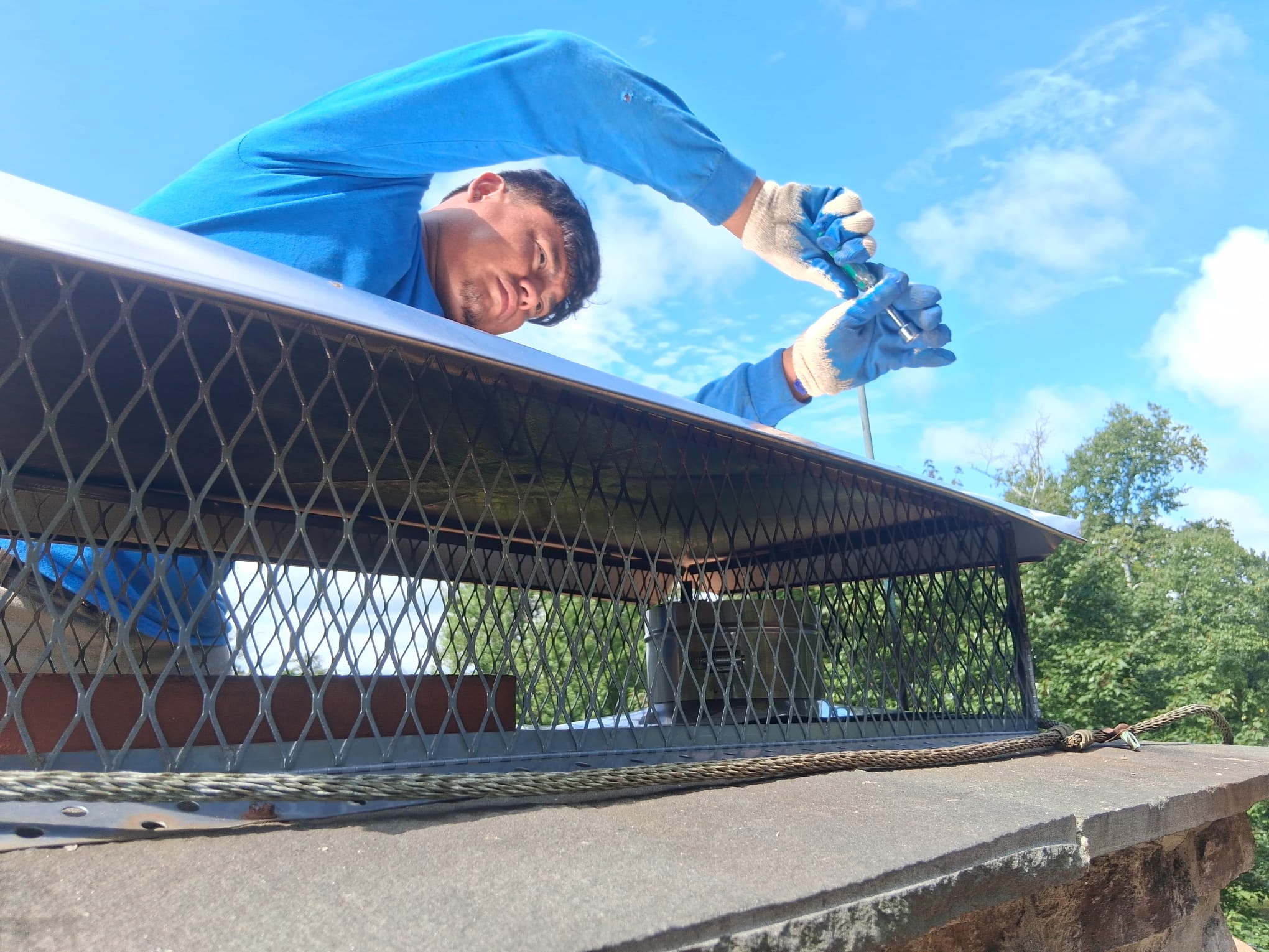 Kent, CT chimney cap installation Spotless Chimney technician securing a chimney cap in Kent, Connecticut