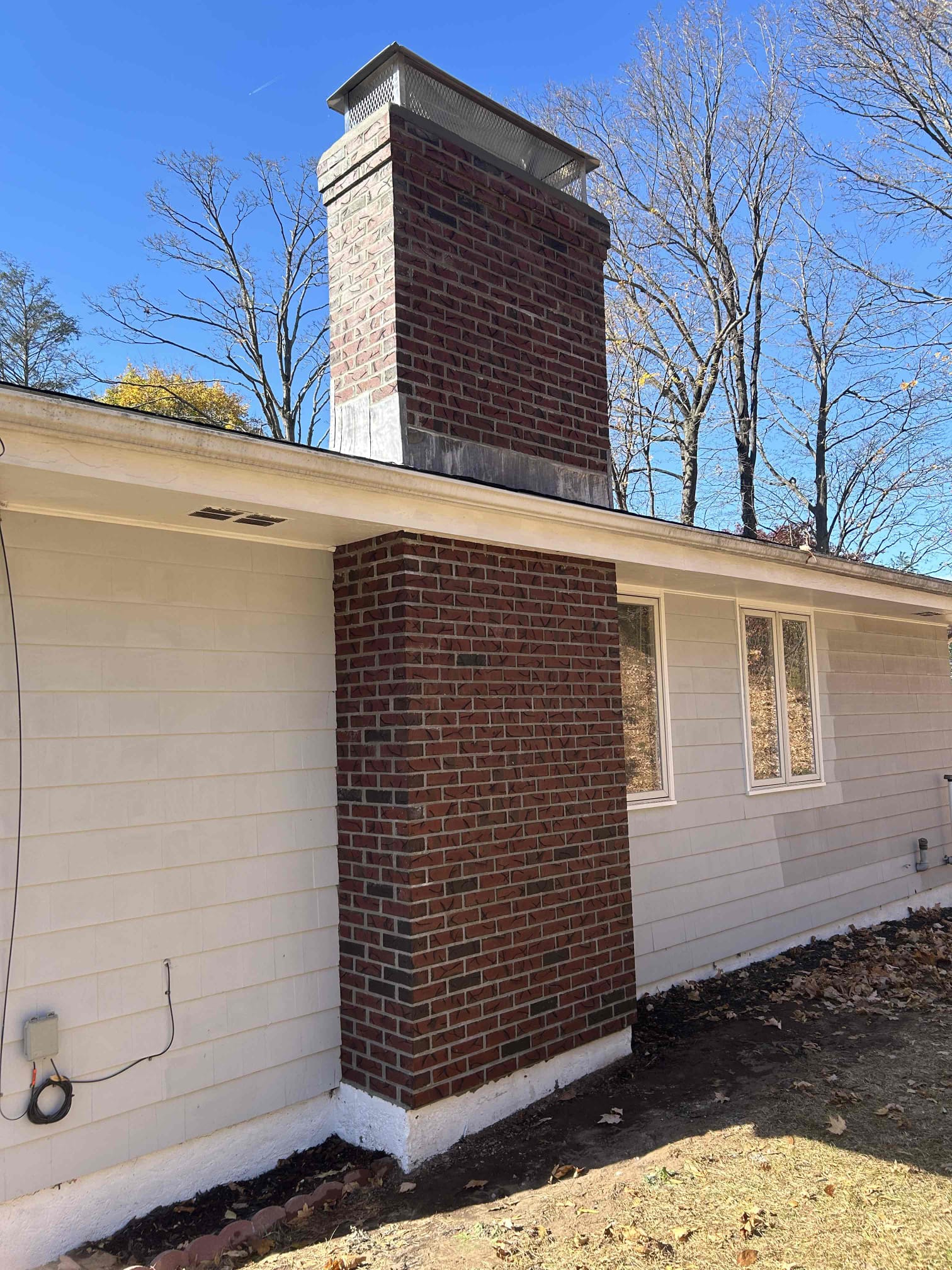 plainville-finished-chimney-rebuild-angle Finished full brick chimney rebuild with cap in Plainville, CT