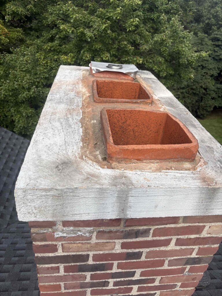 Southington chimney before cap installation Two-flue chimney before a custom cap installation in Southington, Connecticut