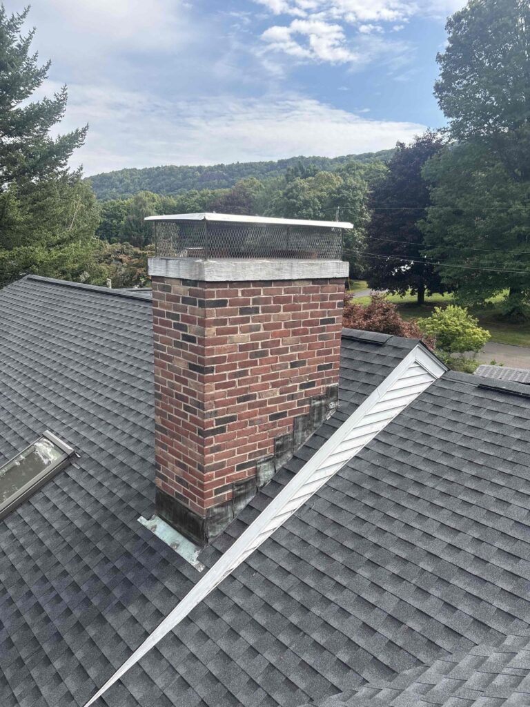 Completed Southington chimney cap installation — wide view Wide view of a completed chimney cap installation on a Southington home