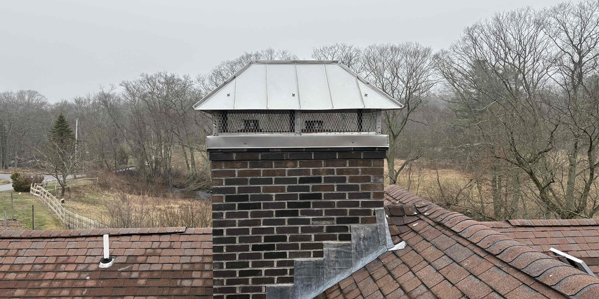 Finished partial chimney rebuild with custom multi-flue cap in Sterling, Connecticut
