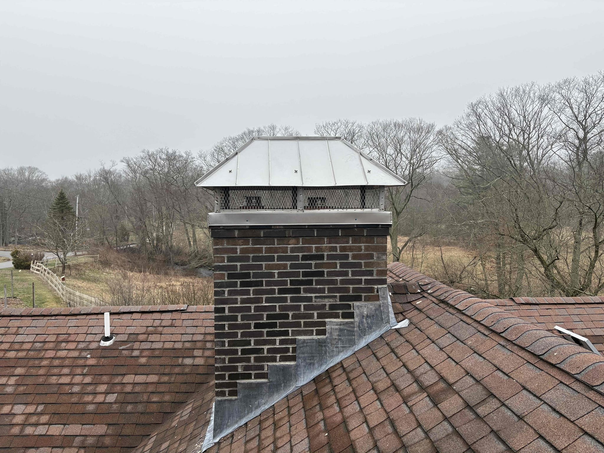 Finished partial chimney rebuild with custom multi-flue cap in Sterling, Connecticut