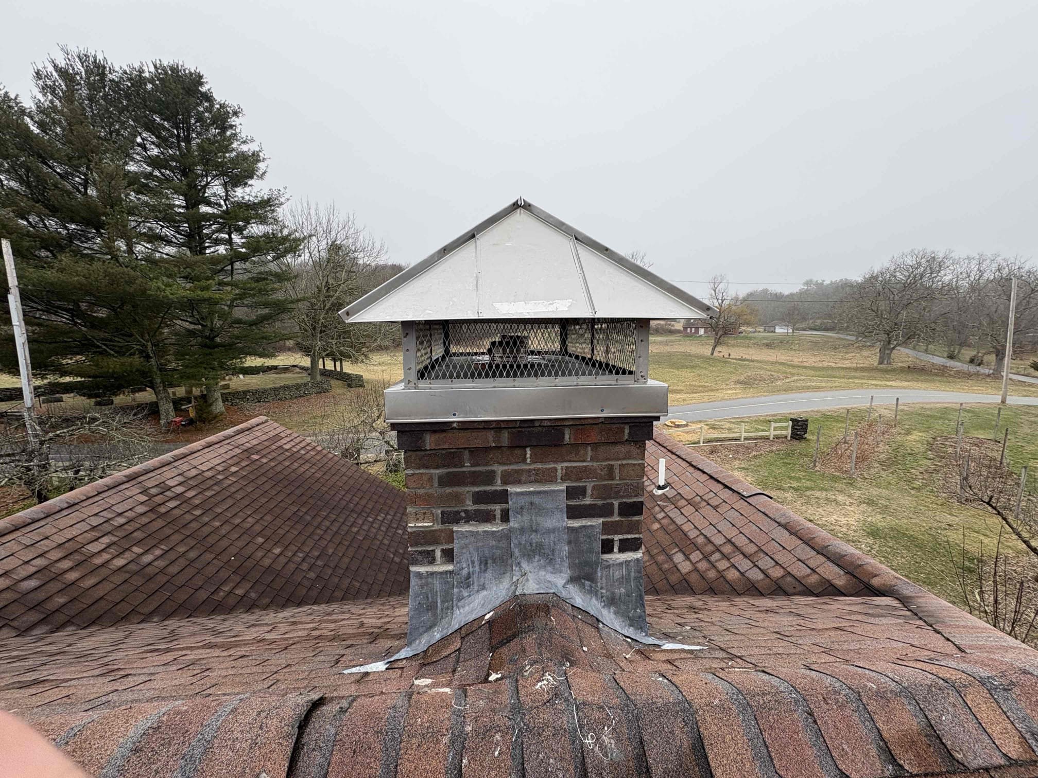 Rebuilt brick chimney with new flashing and custom cap in Sterling, Connecticut